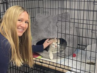 woman with cat in cage