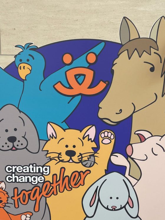 girls behind poster